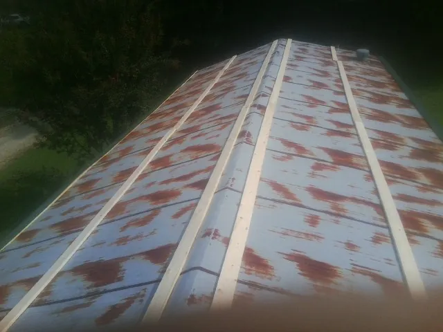 Rusted metal roof panels with new wood purlins before replacement — Storm Damage Roof Repair in Manheim by Roofing Brothers
