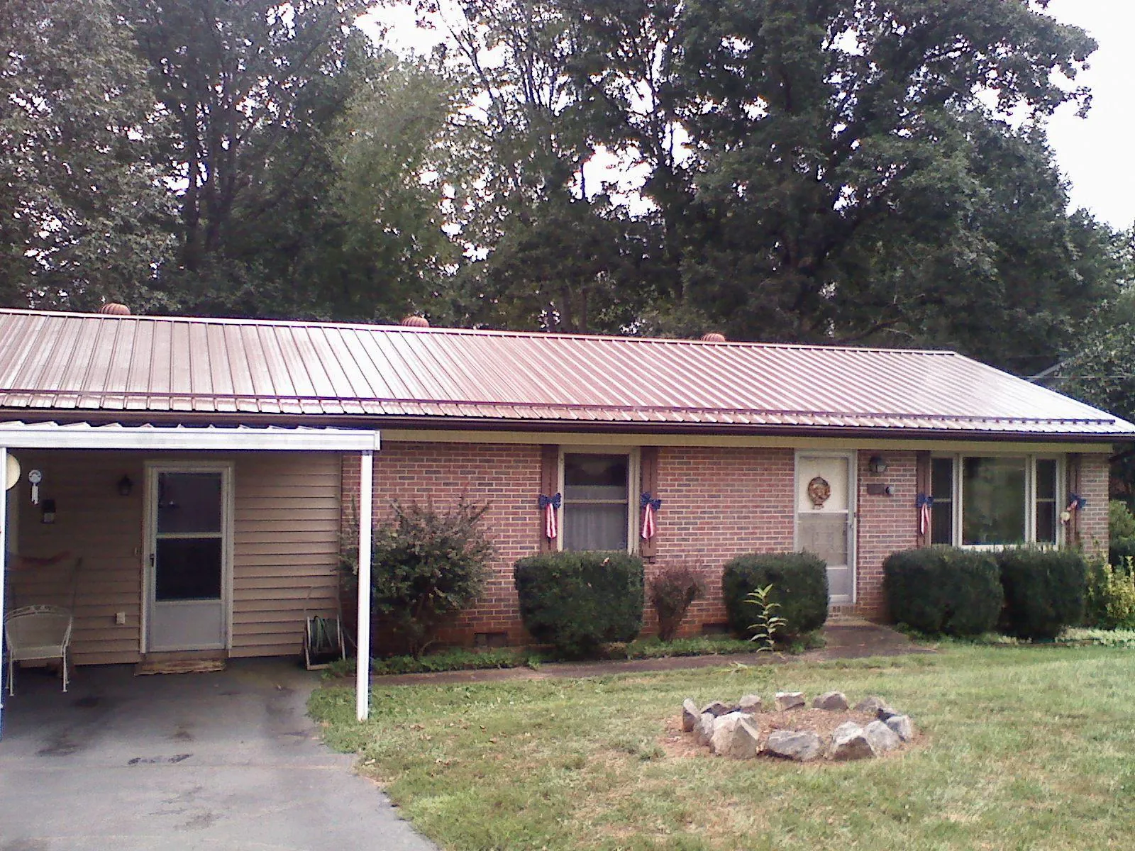 Bronze metal roof and carport on a brick ranch home — Roof Repair work by our crew in Manheim