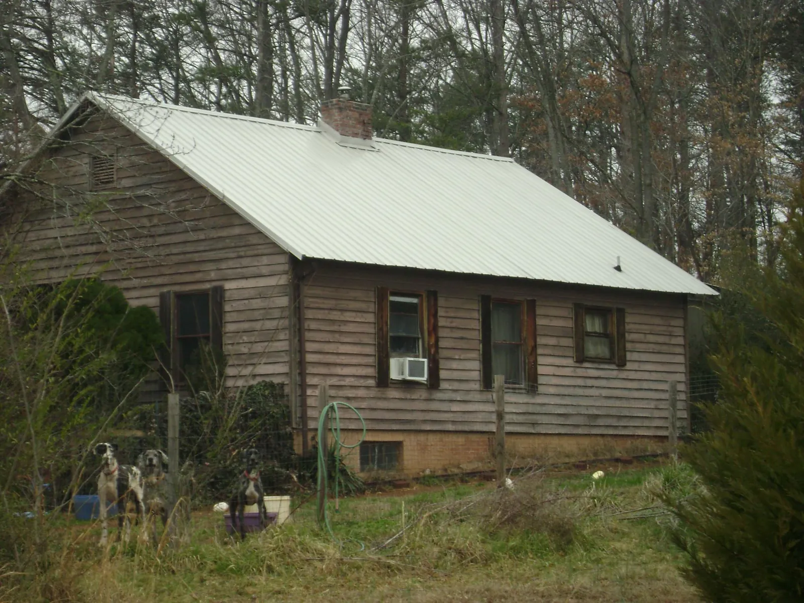 White metal roof on an old wood sided farmhouse, from a Metal Roof Installation job in Manheim